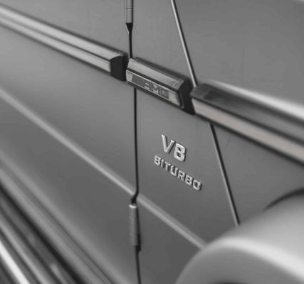pexels-photo-20534679-20534679 Detailed close-up of a Mercedes AMG with V8 Biturbo emblem, showcasing luxury vehicle design.
